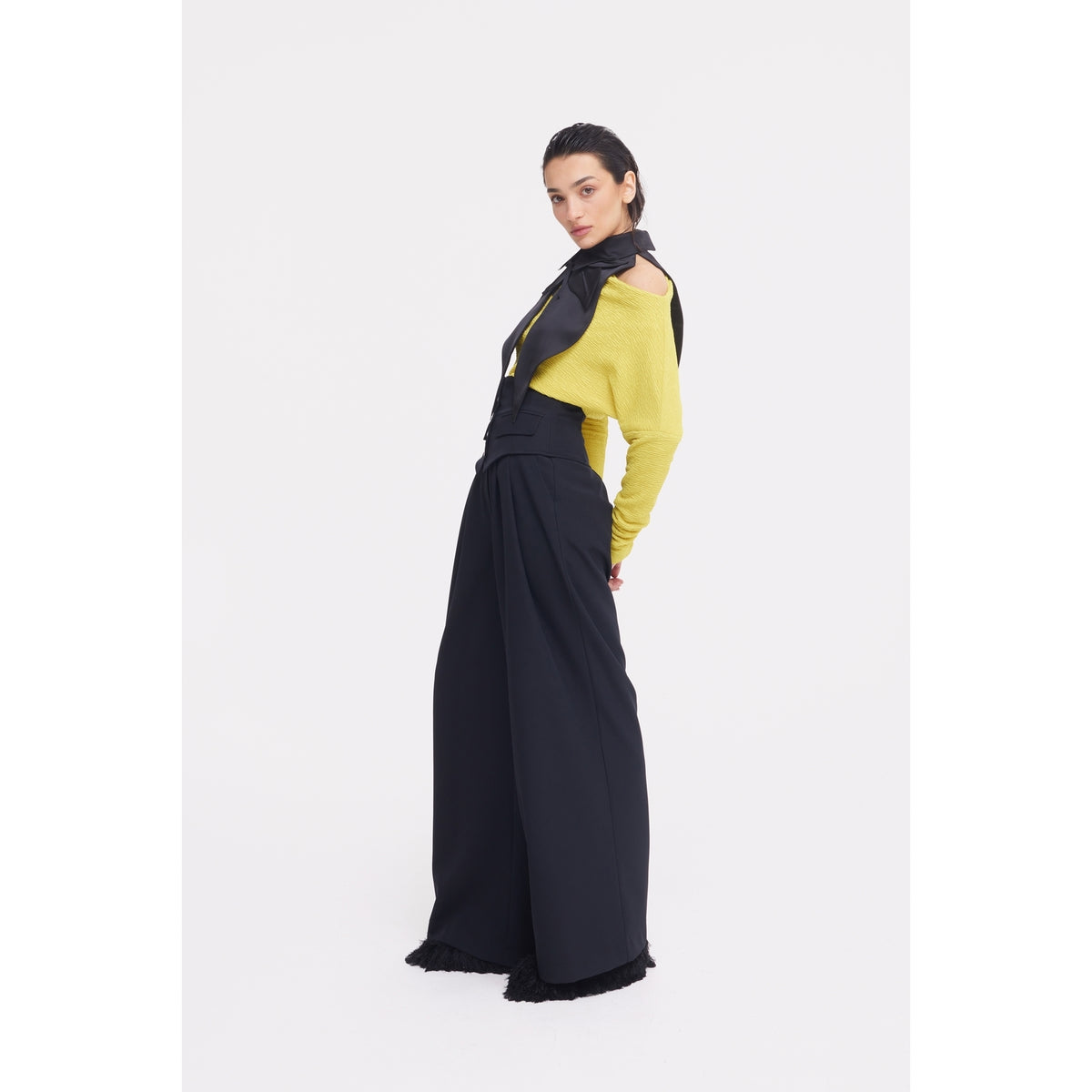 A person poses in a yellow long-sleeve top, JULIA ALLERT Buttoned Corset-Waist Black Tailored Trousers, and a black scarf, standing against a plain white background.