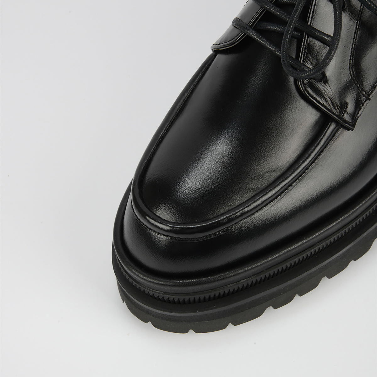 Close-up of the toe and laces on THEN Black Chunky Leather Derby Shoes with a textured lug sole, shown against a plain white background.
