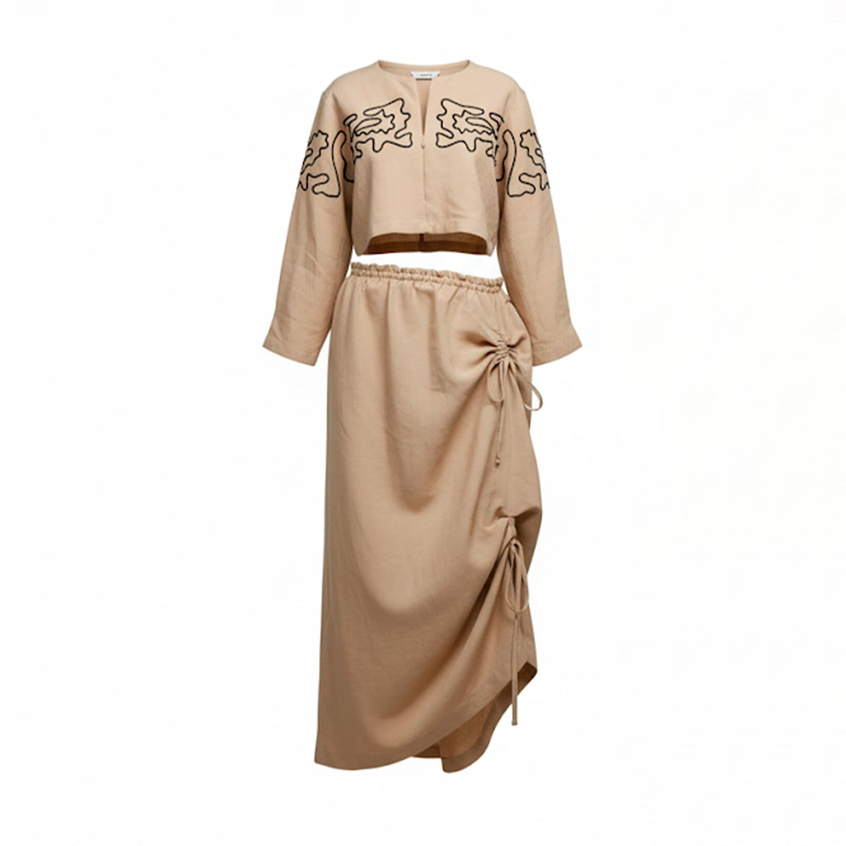Beige outfit with embroidered top and tied skirt on a white background