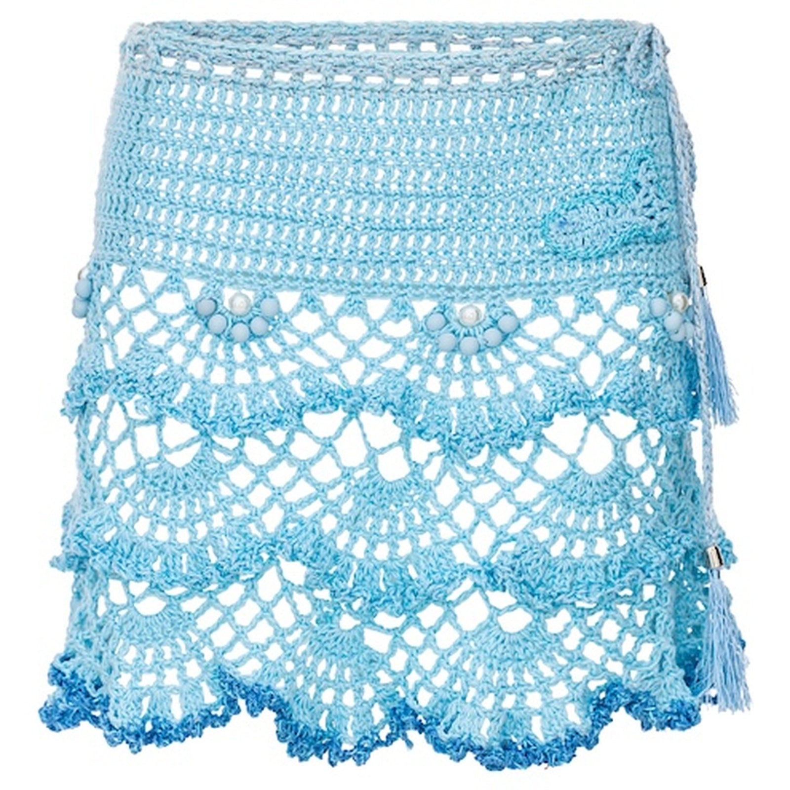 The ANDREEVA Aqua Marine Handmade Mini Crochet Skirt features scalloped openwork patterns, pearl-like beads, and a fringe tassel—a stylish bohemian beachwear piece with an intricate lacy design in varied blue shades.