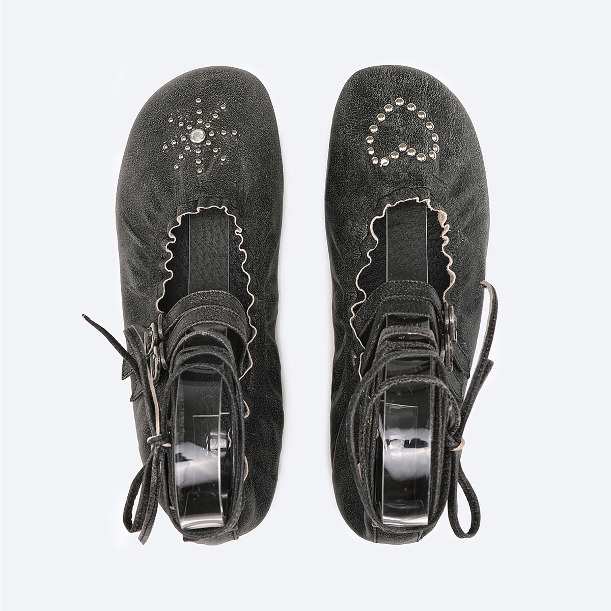 THEN Black Distressed Lace-Up Ballerina Flats: Handcrafted in Korea, these flats feature ankle straps, scalloped edges, and decorative studs with a starburst on the left toe and a heart on the right.