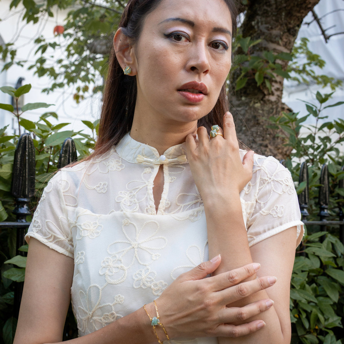 Woman wearing a white lace top with a bow tie in an outdoor setting