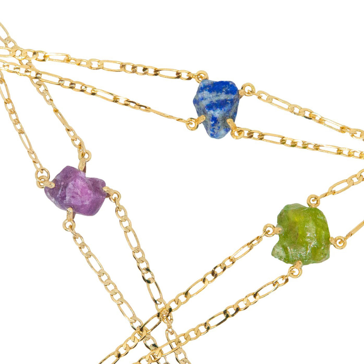 Gold chain necklaces with embedded stones on a white background