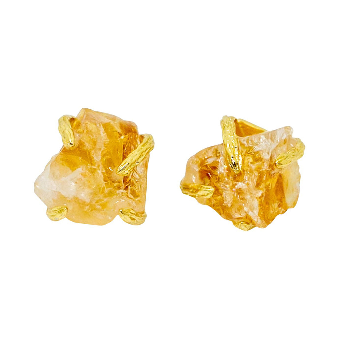 Gold and stone earrings on a white background