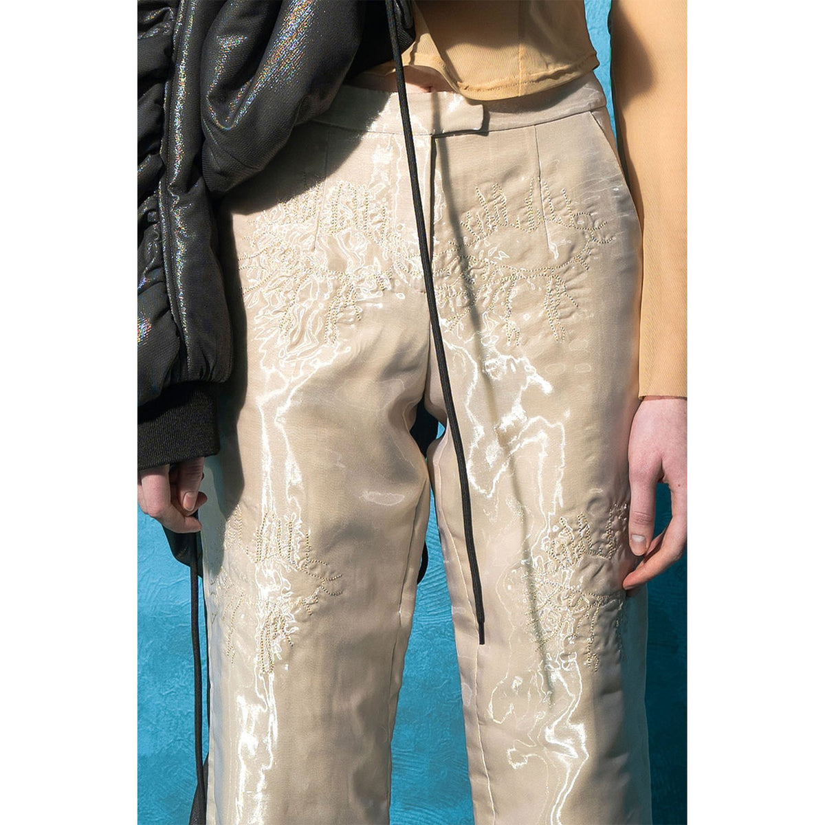 Model wearing beige padded organza straight pants