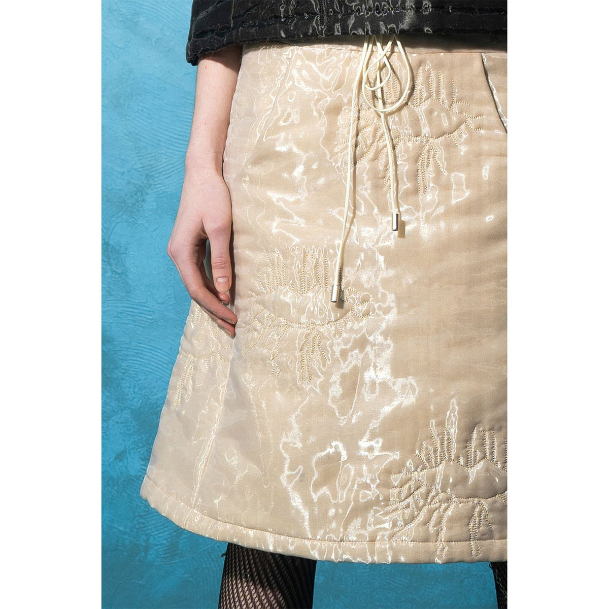 Model wearing beige padded organza trapeze skirt 