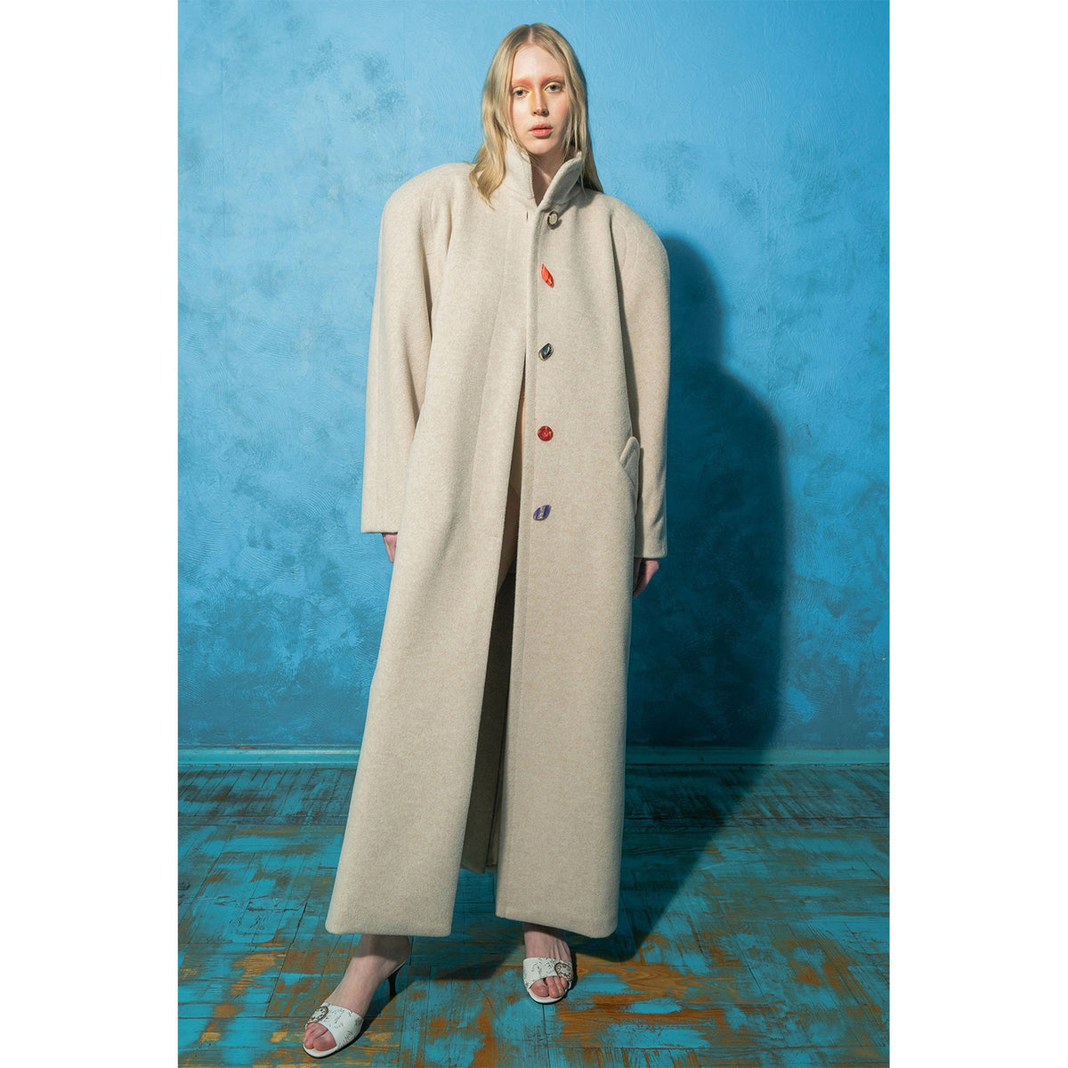 Model wearing beige wool-blend maxi coat with vintage buttons by MASHAT