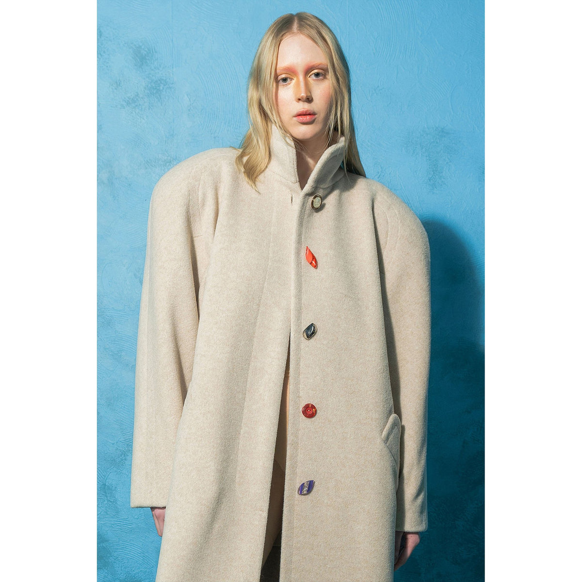 Model wearing beige wool-blend maxi coat with vintage buttons by MASHAT