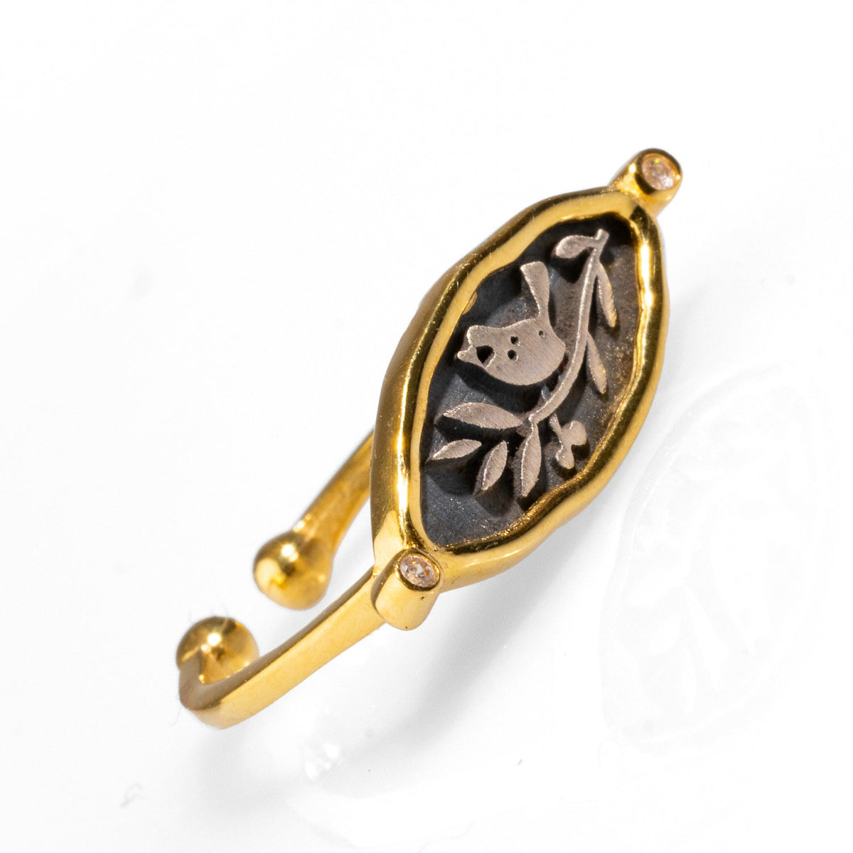 Delicate signet ring featuring olive leaf and bird engravings on a sterling silver face, enhanced with 18k gold plating