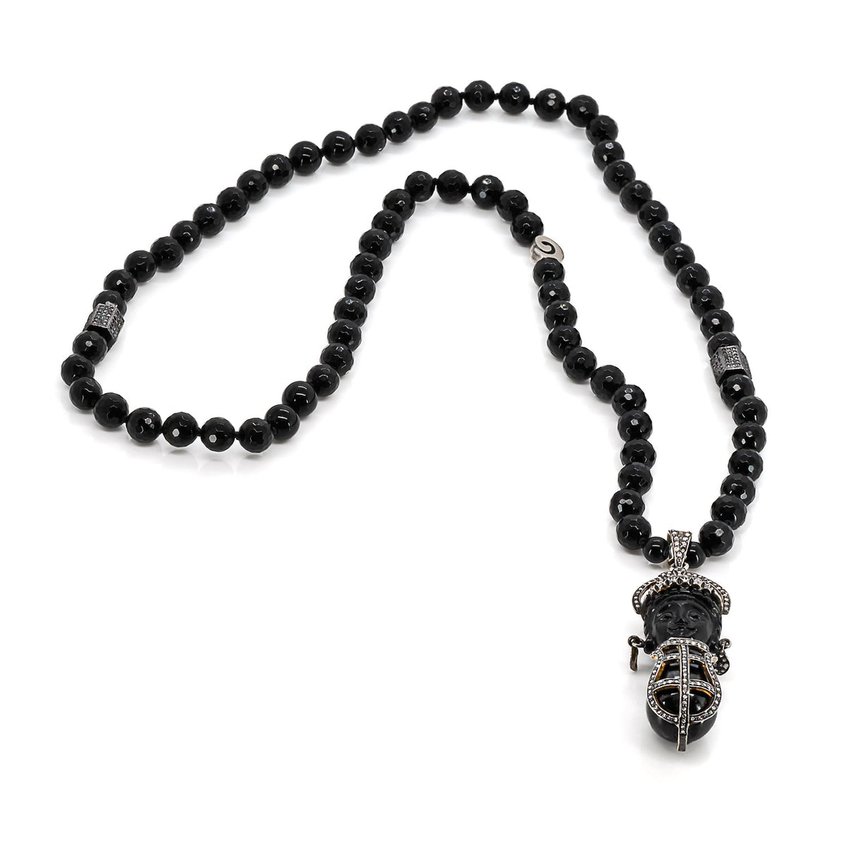 Black onyx stone beaded necklace with a detailed pave diamond pendant, highlighting cultural richness and sophistication