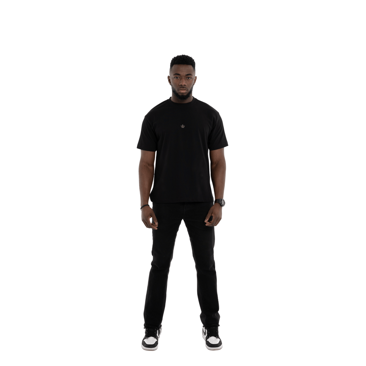 Man wearing a black t-shirt and pants on a white background