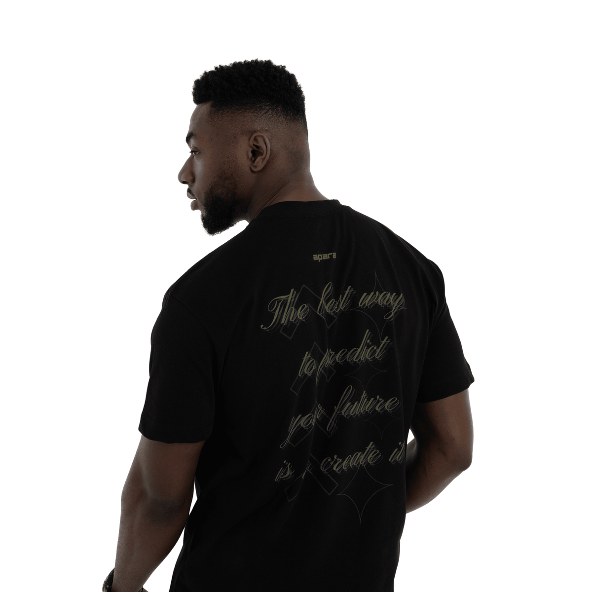 Man wearing a black t-shirt with text on the back, standing against a white background