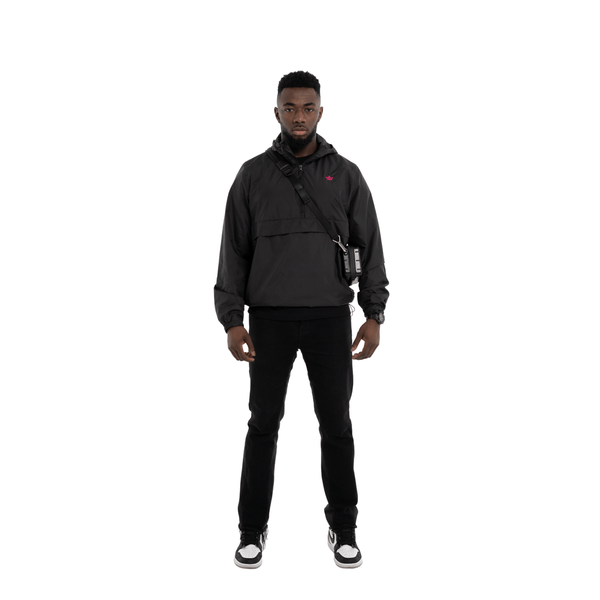 Person wearing a black hoodie and pants on a white background