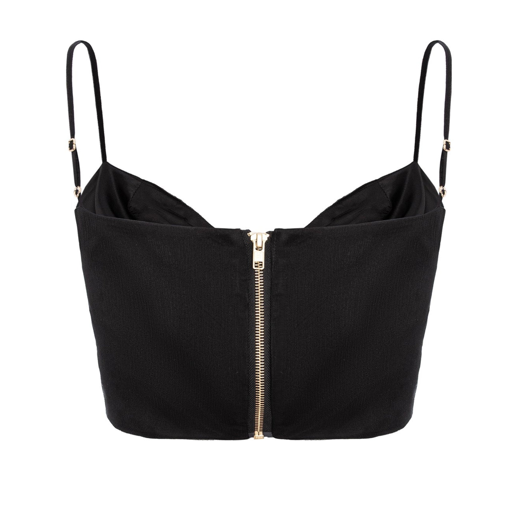 Black crop top with thin straps and zipper on a white background
