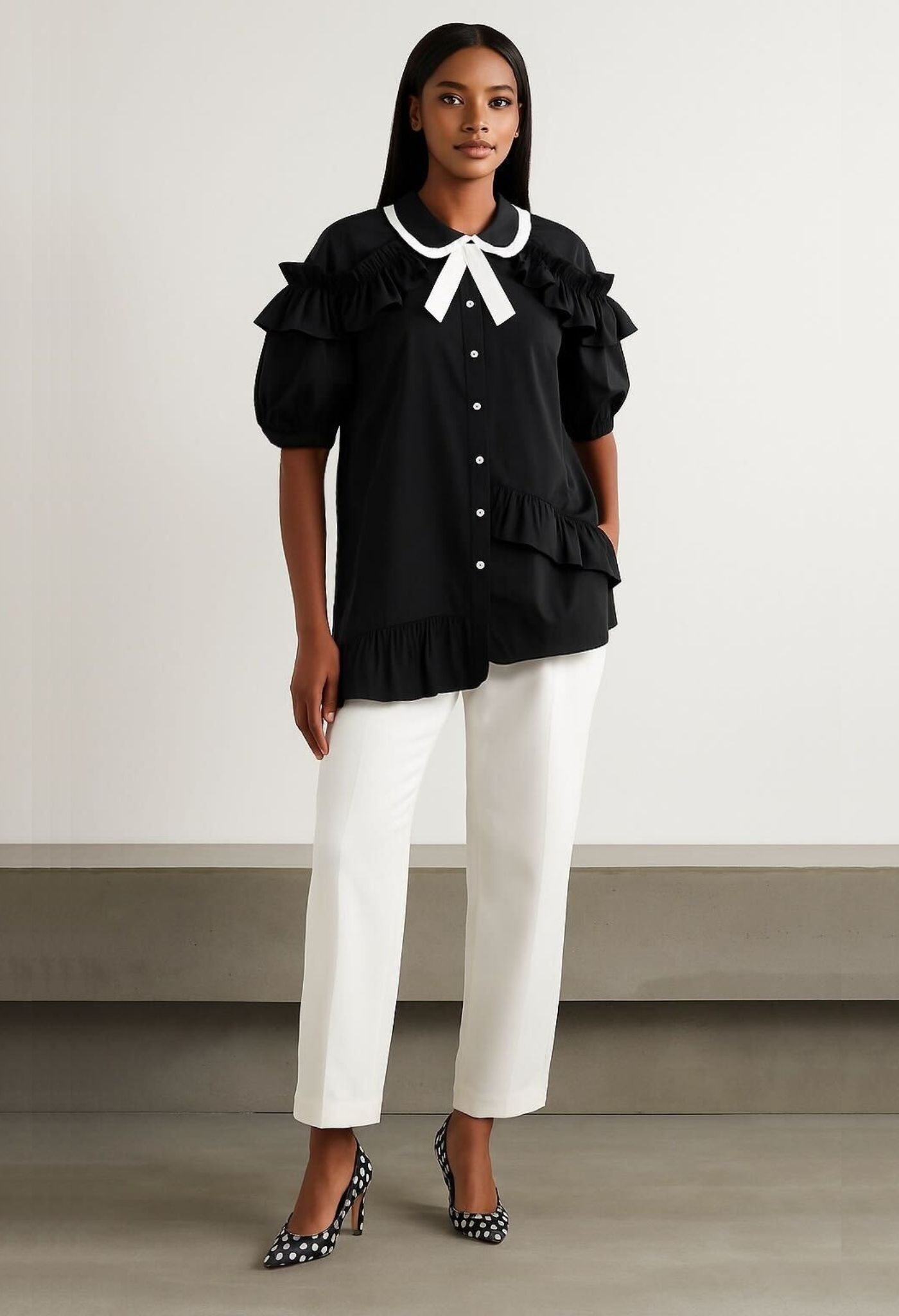 Model wearing black romantic statement asymmetric puff sleeve ruffle blouse