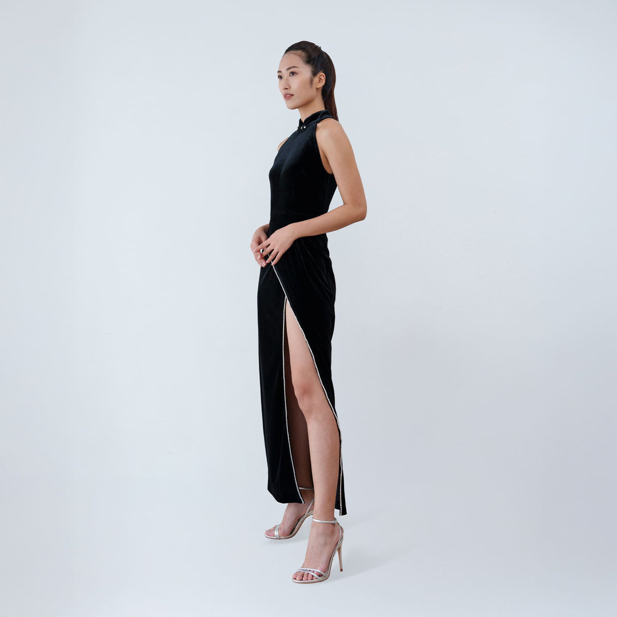 Qipology black velvet halter qipao dress with crystal-trimmed Mandarin collar and high front slit, worn by model, look 3, buy at DOORS NYC
