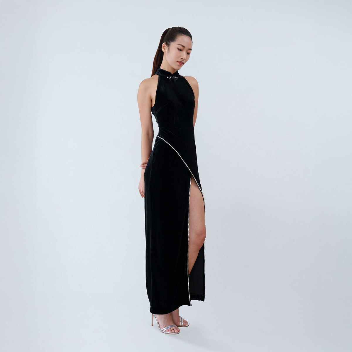 Qipology black velvet halter qipao dress with crystal-trimmed Mandarin collar and high front slit, worn by model, look 4, buy at DOORS NYC
