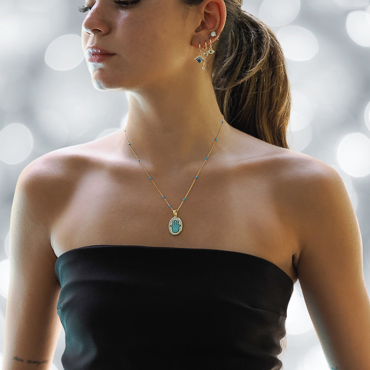 Model Wearing a Hamsa Good Fortune Turquoise &amp; Gold Chain Necklace - Embodying Protection and Style.