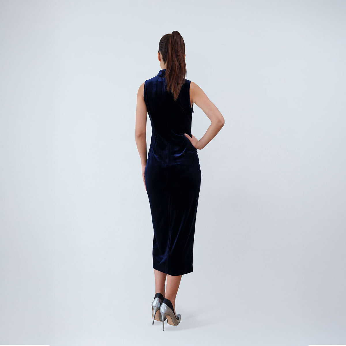 Qipology navy blue velvet sleeveless qipao dress with Mandarin collar, beaded detail and front slit, worn by model, look 6, buy at DOORS NYC