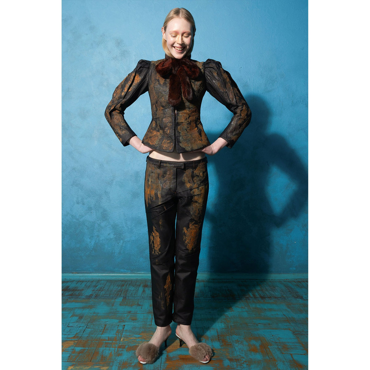 Model wearing black rust-effect faux leather straight-leg trousers by MASHAT