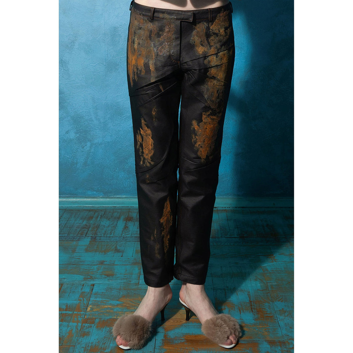 Model wearing black rust-effect faux leather straight-leg trousers by MASHAT