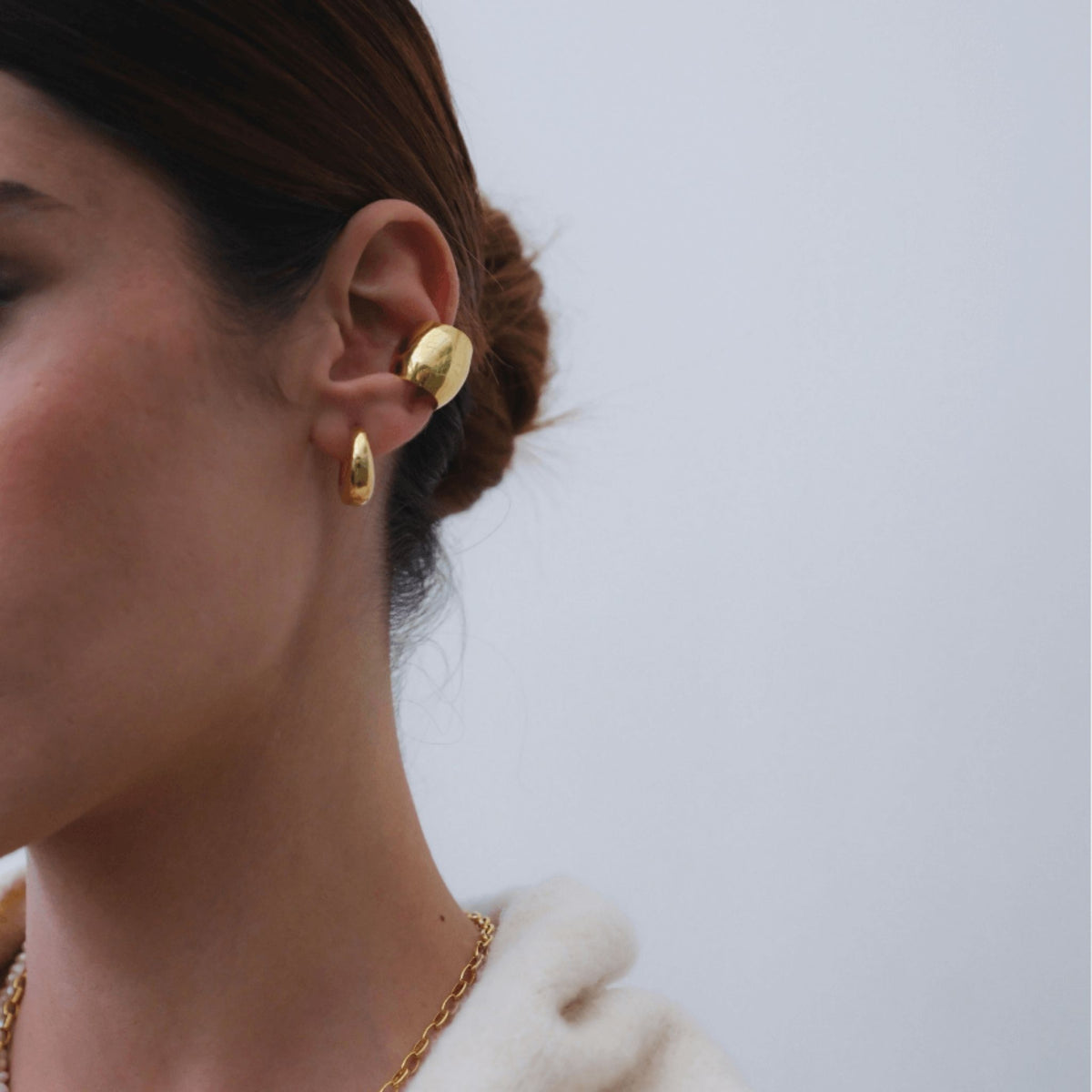 LINYA JEWELRY - Chunky Huggie Hoop Earrings | Gold, buy at DOORS NYC