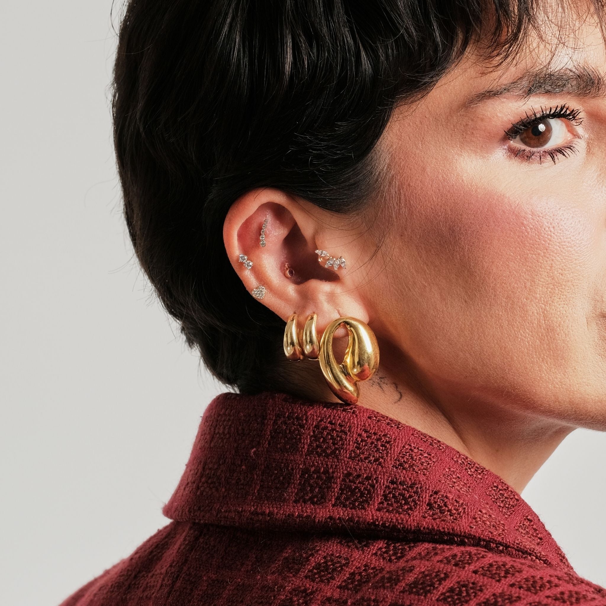 LINYA JEWELRY - Chunky Huggie Hoop Earrings | Gold, buy at DOORS NYC