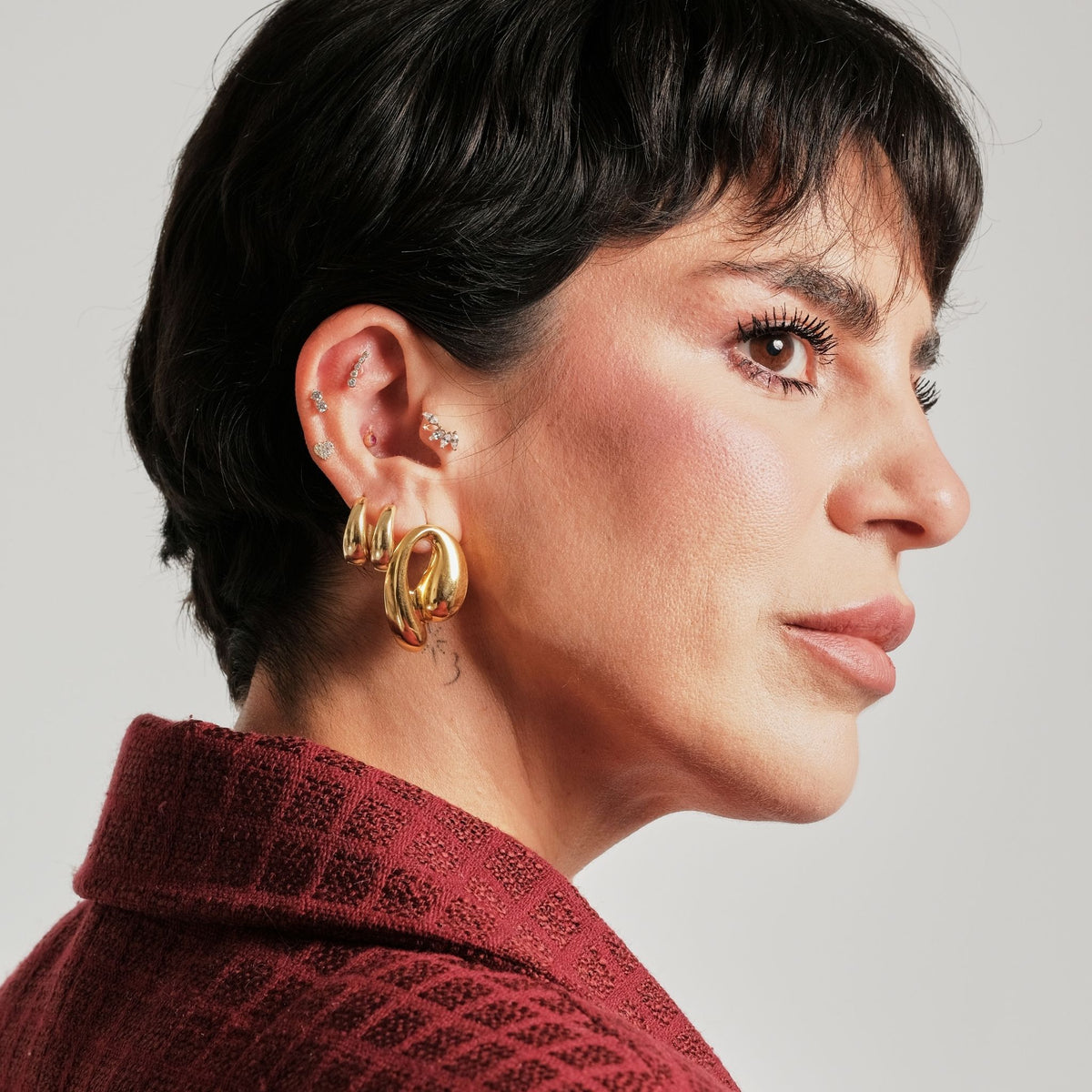 LINYA JEWELRY - Chunky Huggie Hoop Earrings | Gold, buy at DOORS NYC