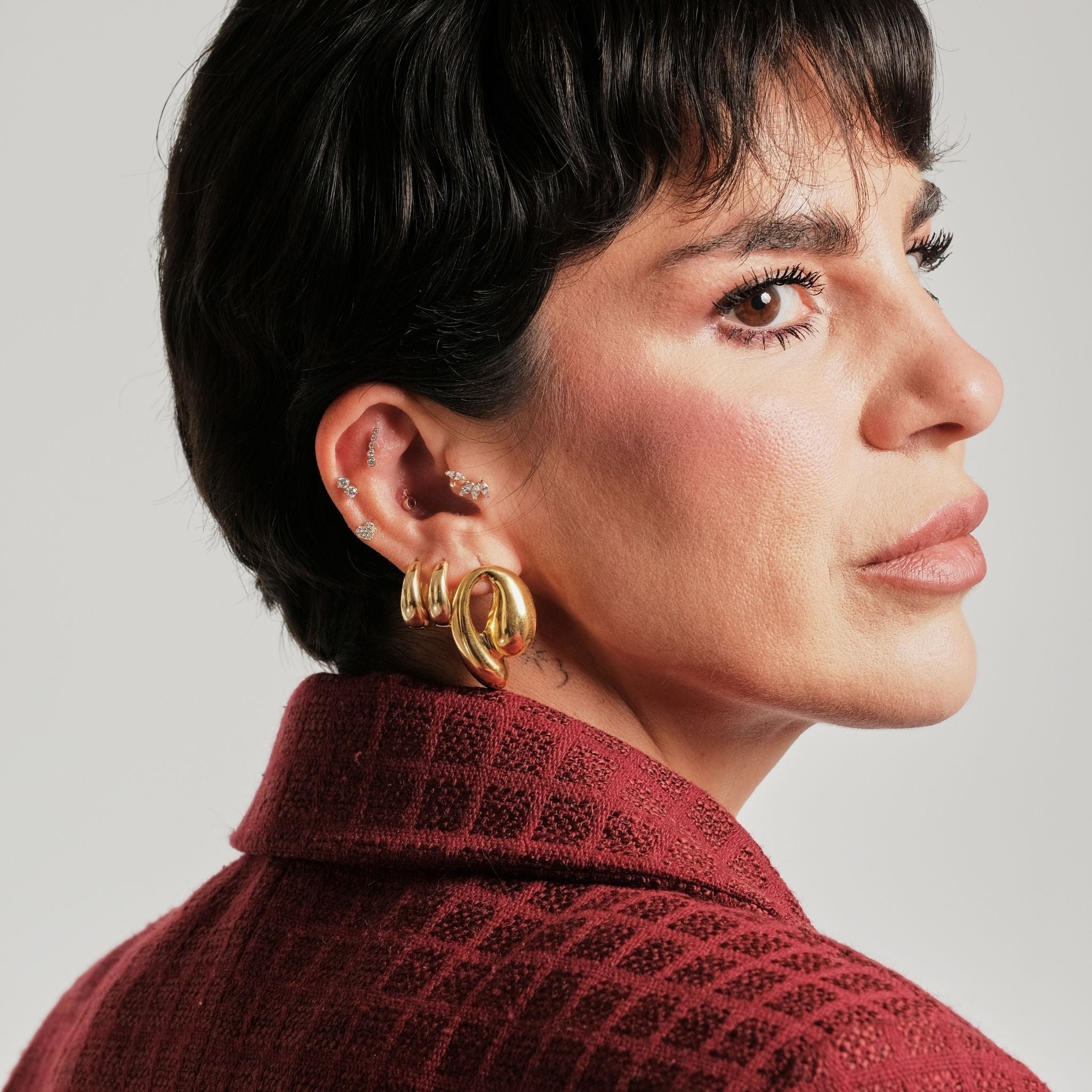 LINYA JEWELRY - Chunky Huggie Hoop Earrings | Gold, buy at DOORS NYC