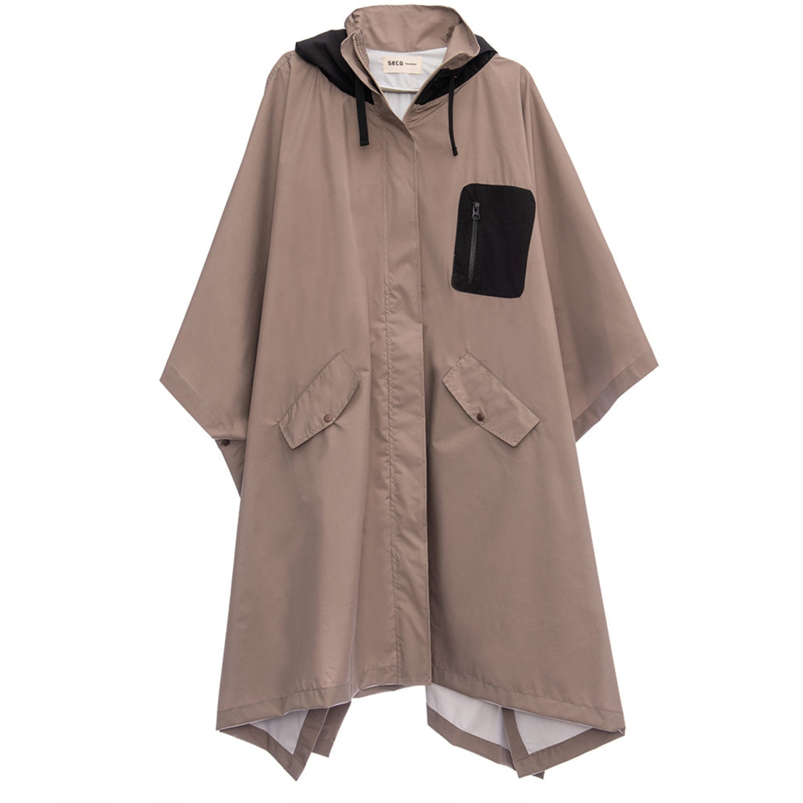 The Vision Parka Lupe from SECO RAINWEAR is a taupe rain poncho featuring a black hood, black zippered chest pocket, and two front flap pockets. Designed with an asymmetrical hem and wide, loose-fitting sleeves, it offers an effortlessly stylish layer in a true mink neutral parka palette.