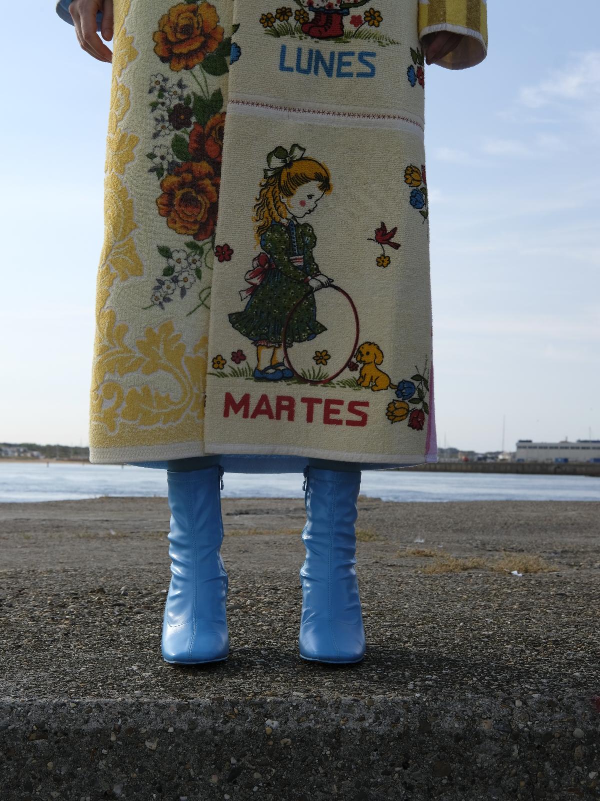 STUDIO WUNDERBAR Long Lunes Martes Coat: multicolor floral patchwork long coat with sunshine yellow florals, electric blue accents, pink and blue rose panels and vintage children illustrations, upcycled one-of-a-kind coat, worn by model, buy at DOORS NYC
