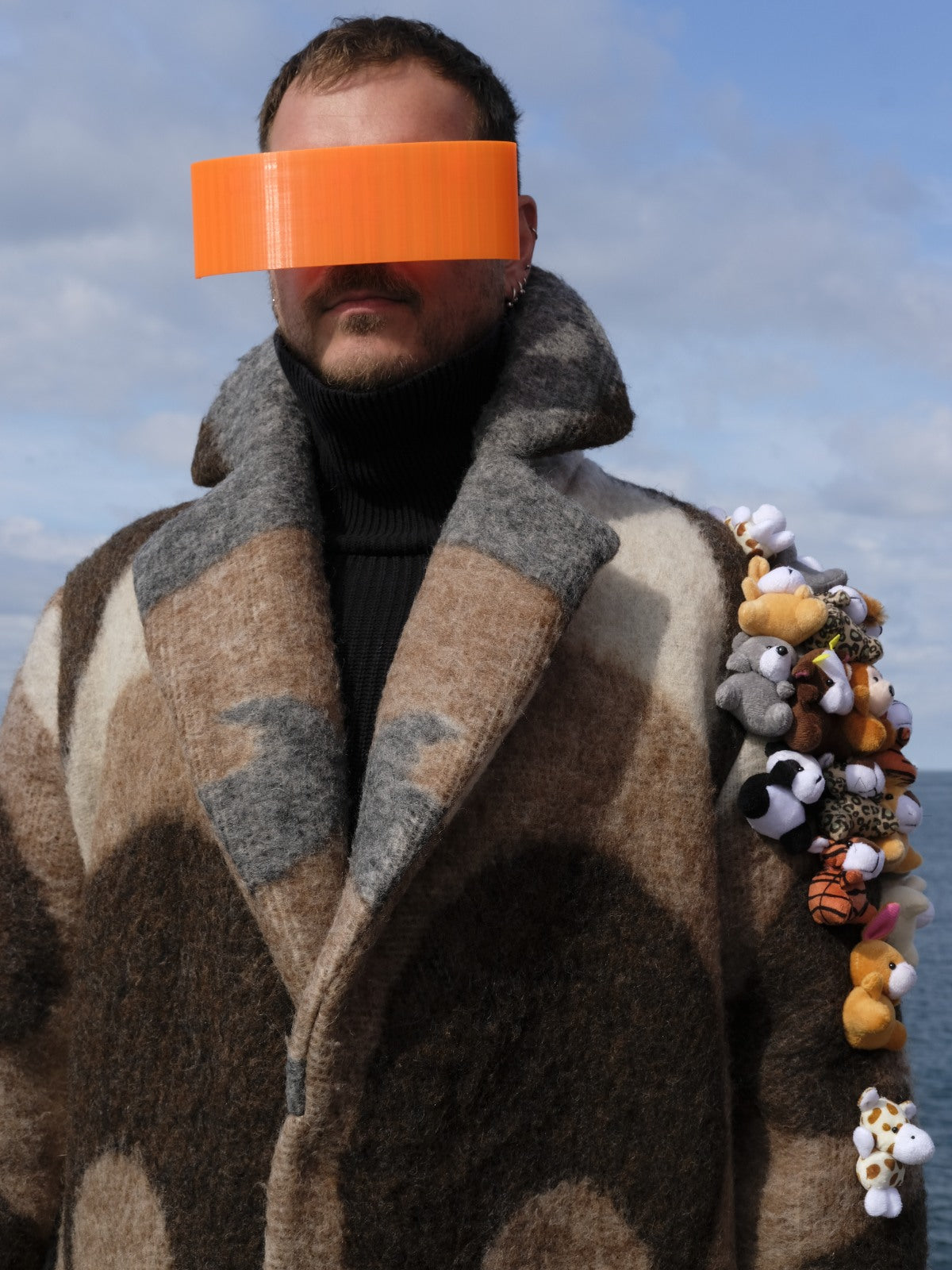 STUDIO WUNDERBAR Brown Cuddly Shoulder Coat: brown and cream retro swirl long coat with plush toys on the shoulder, upcycled one-of-a-kind coat, worn by model, buy at DOORS NYC