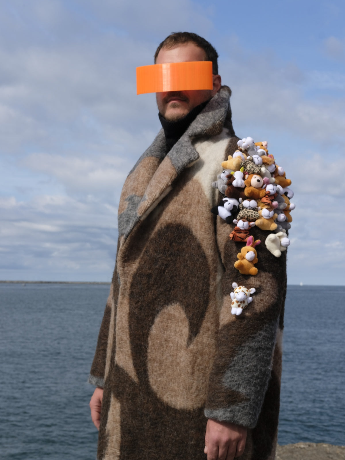 STUDIO WUNDERBAR Brown Cuddly Shoulder Coat: brown and cream retro swirl long coat with plush toys on the shoulder, upcycled one-of-a-kind coat, worn by model, buy at DOORS NYC