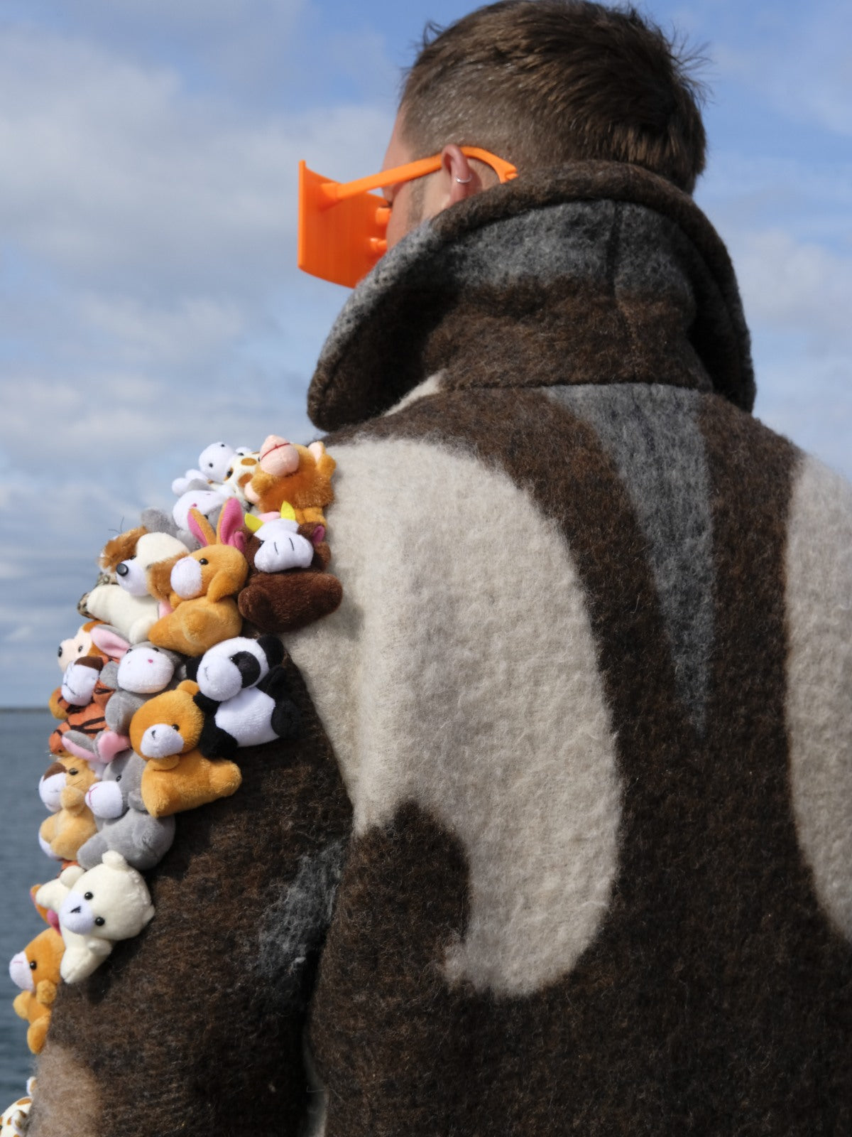 STUDIO WUNDERBAR Brown Cuddly Shoulder Coat: brown and cream retro swirl long coat with plush toys on the shoulder, upcycled one-of-a-kind coat, worn by model, buy at DOORS NYC