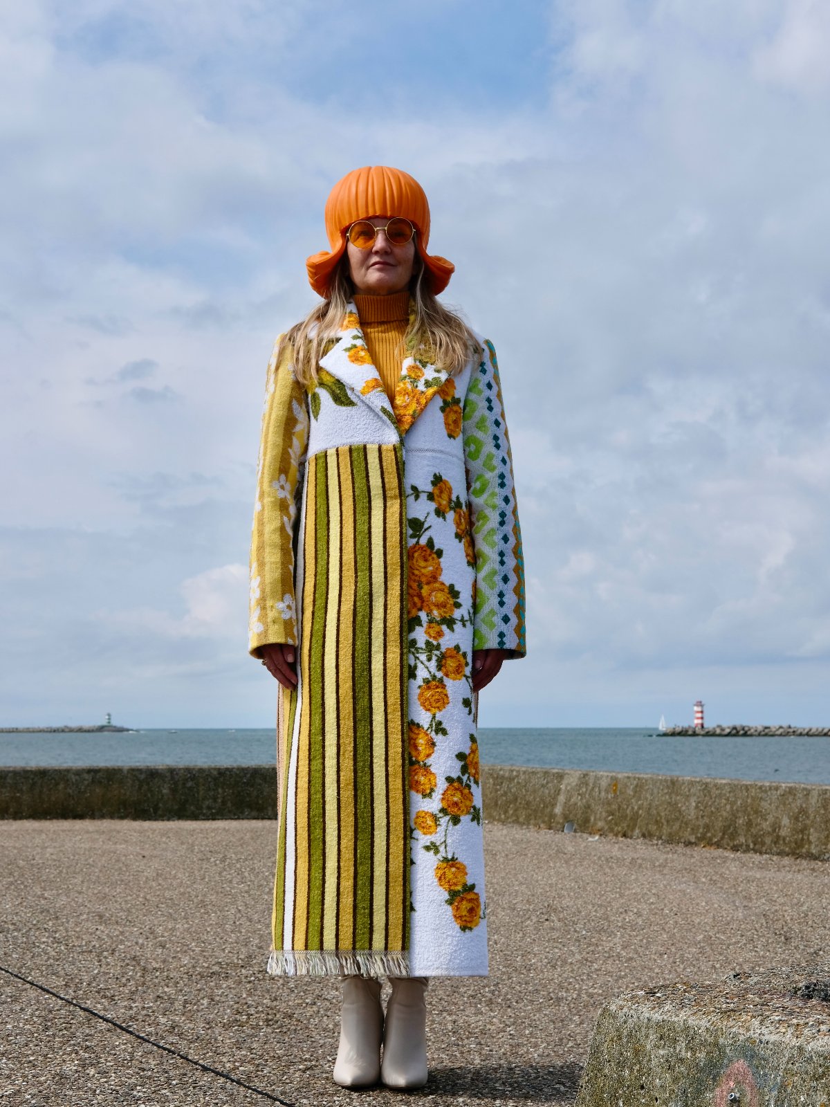 STUDIO WUNDERBAR Hella Horse Coat: blue floral patchwork long coat with yellow roses, striped panels, fringe hem and a horse panel on the back, upcycled one-of-a-kind coat, worn by model, buy at DOORS NYC