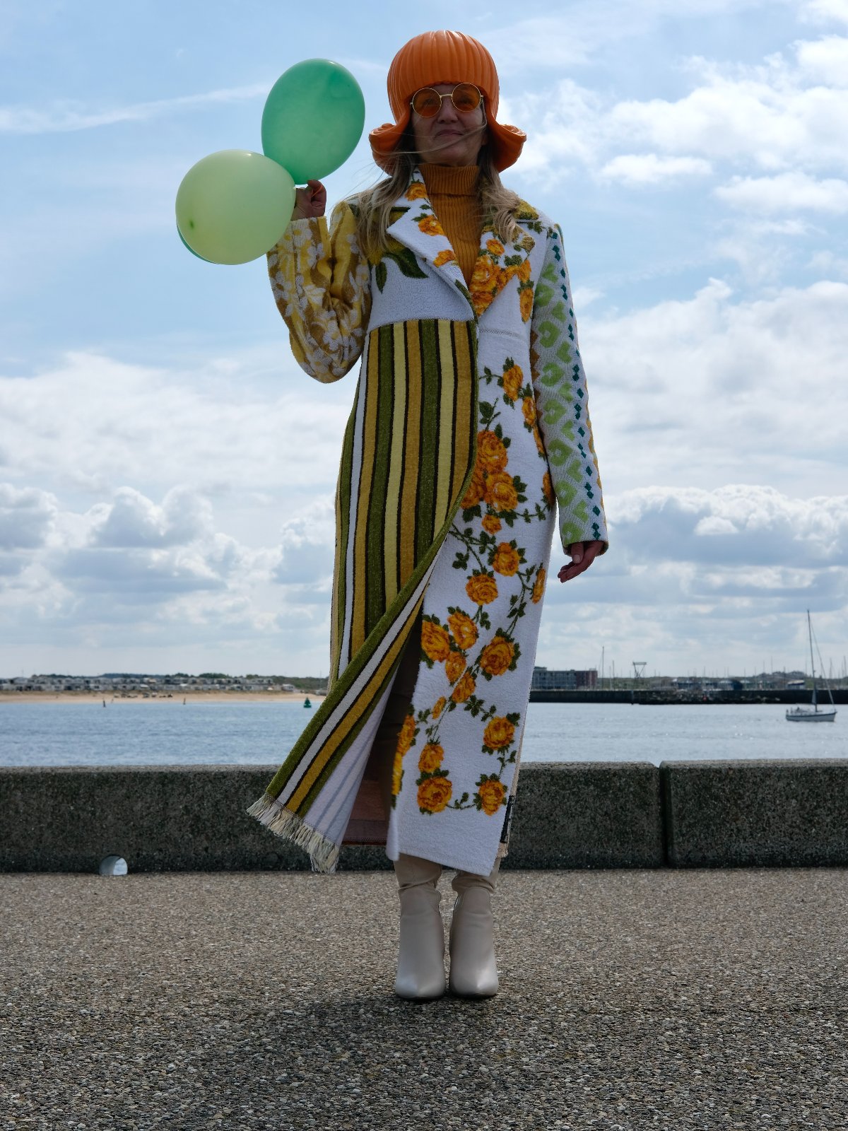 STUDIO WUNDERBAR Hella Horse Coat: blue floral patchwork long coat with yellow roses, striped panels, fringe hem and a horse panel on the back, upcycled one-of-a-kind coat, worn by model, buy at DOORS NYC