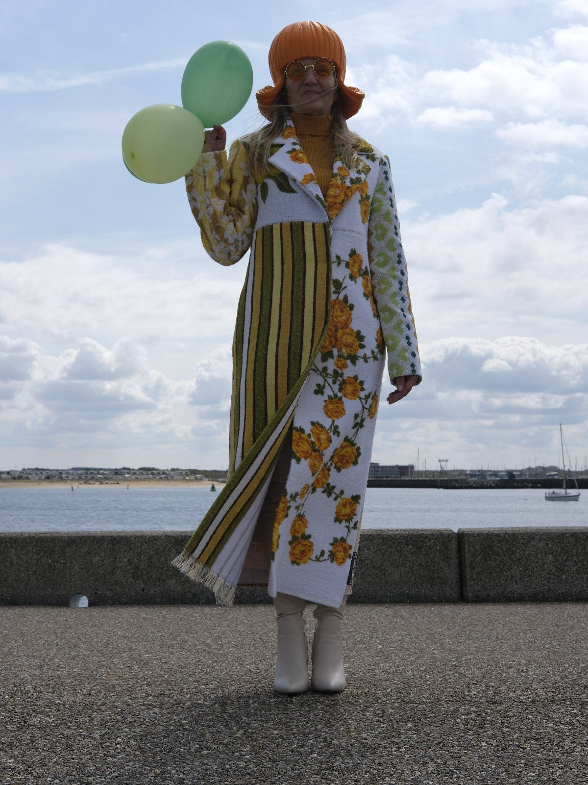 STUDIO WUNDERBAR Hella Horse Coat: blue floral patchwork long coat with yellow roses, striped panels, fringe hem and a horse panel on the back, upcycled one-of-a-kind coat, worn by model, buy at DOORS NYC