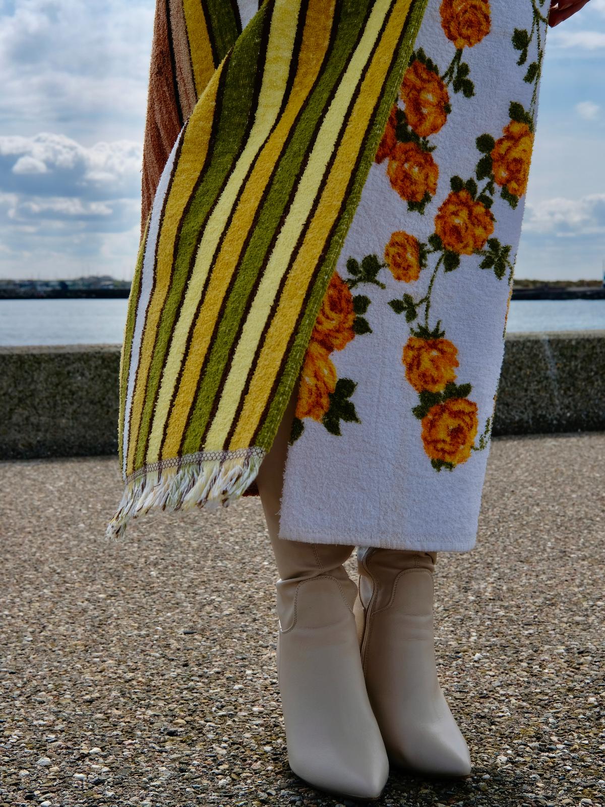 STUDIO WUNDERBAR Hella Horse Coat: blue floral patchwork long coat with yellow roses, striped panels, fringe hem and a horse panel on the back, upcycled one-of-a-kind coat, worn by model, buy at DOORS NYC