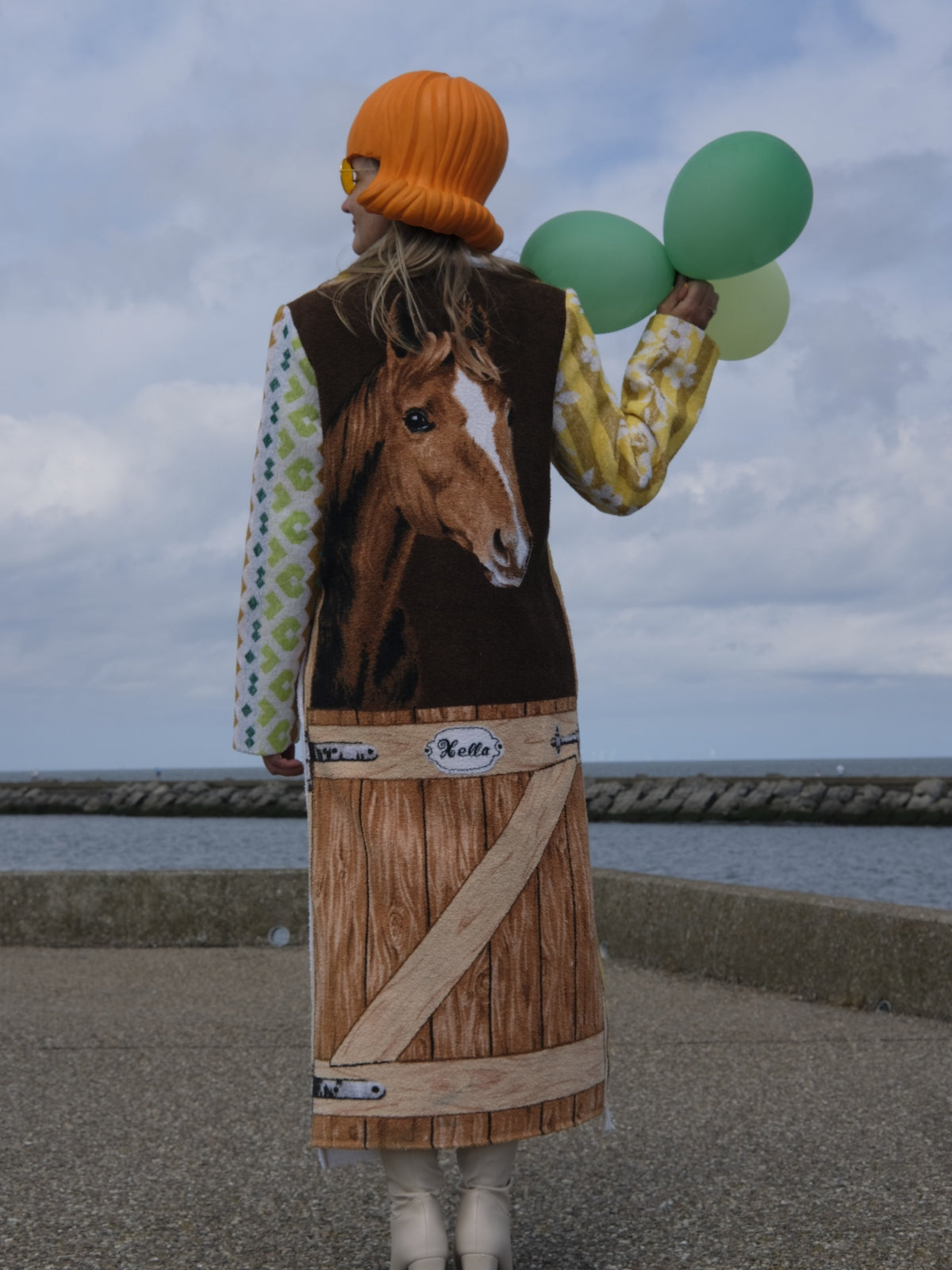 STUDIO WUNDERBAR Hella Horse Coat: blue floral patchwork long coat with yellow roses, striped panels, fringe hem and a horse panel on the back, upcycled one-of-a-kind coat, worn by model, buy at DOORS NYC