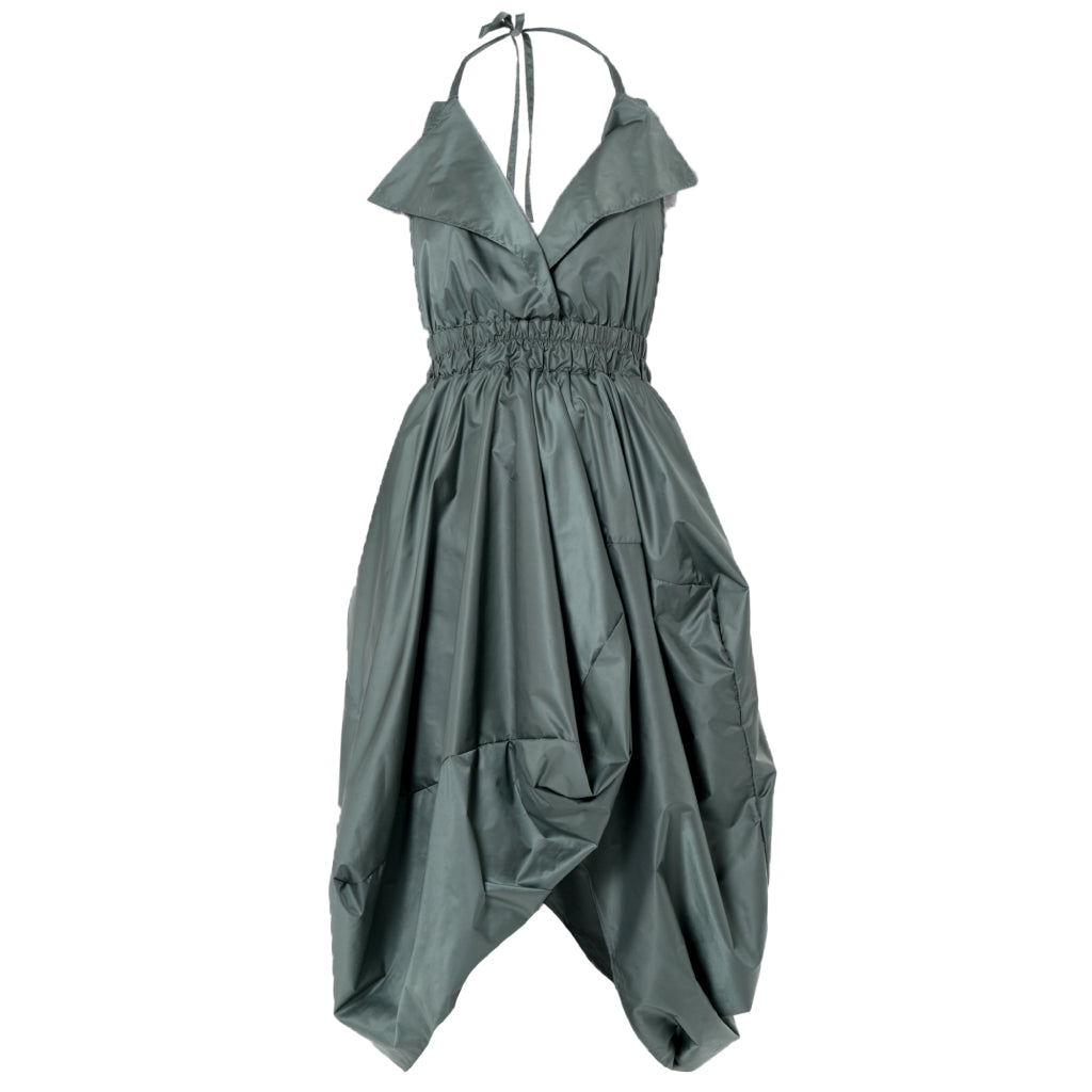 The Draped Balloon Pinafore Dress in Green by METAMORPHOZA features a sleeveless halter neckline, deep V-neck, gathered elastic waist, large collar, voluminous draped skirt with angular folds, and a side pocket for an avant-garde look.