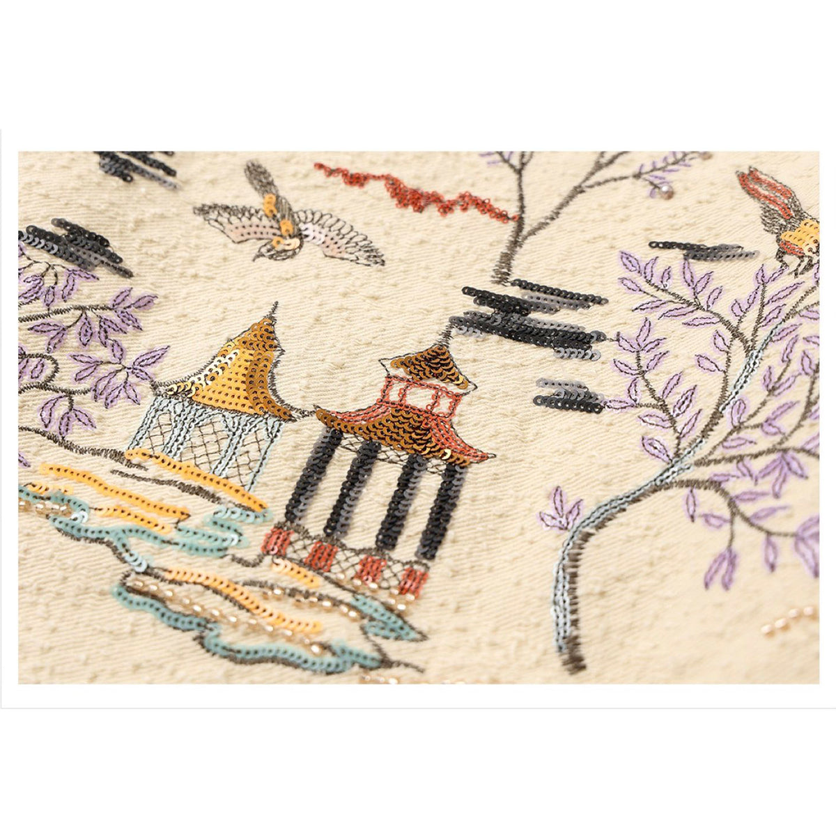 Embroidered design of pagodas and birds on a beige background