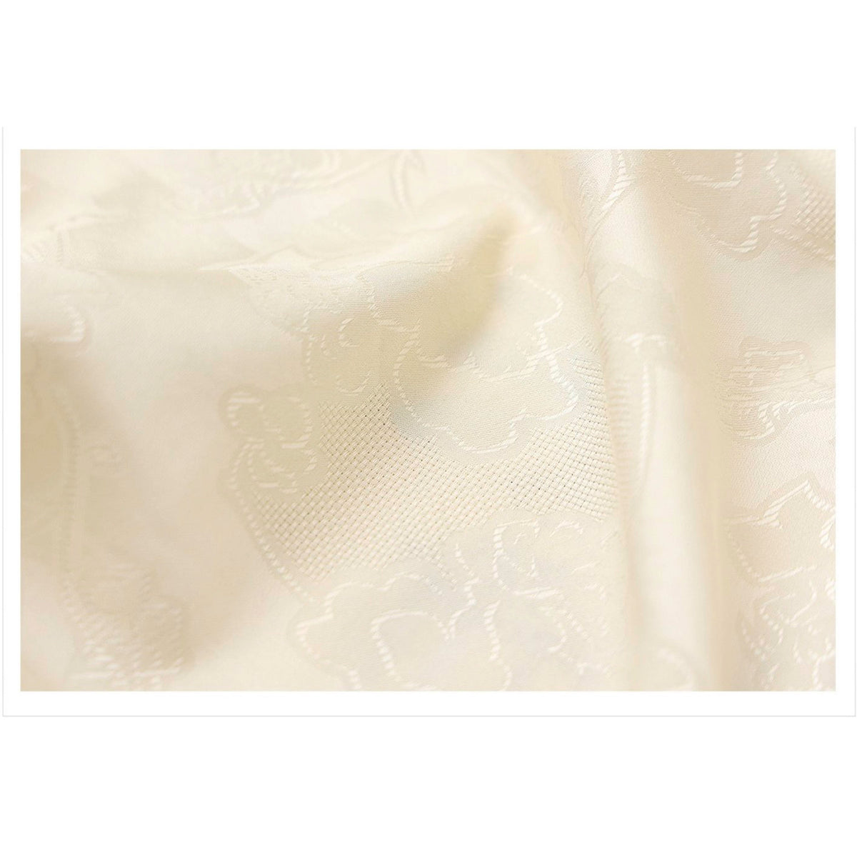 Close-up of textured white fabric with subtle patterns