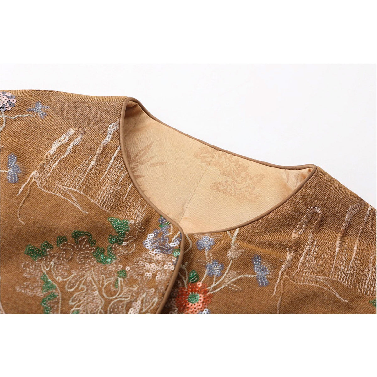 Embroidered fabric with floral patterns on a beige background