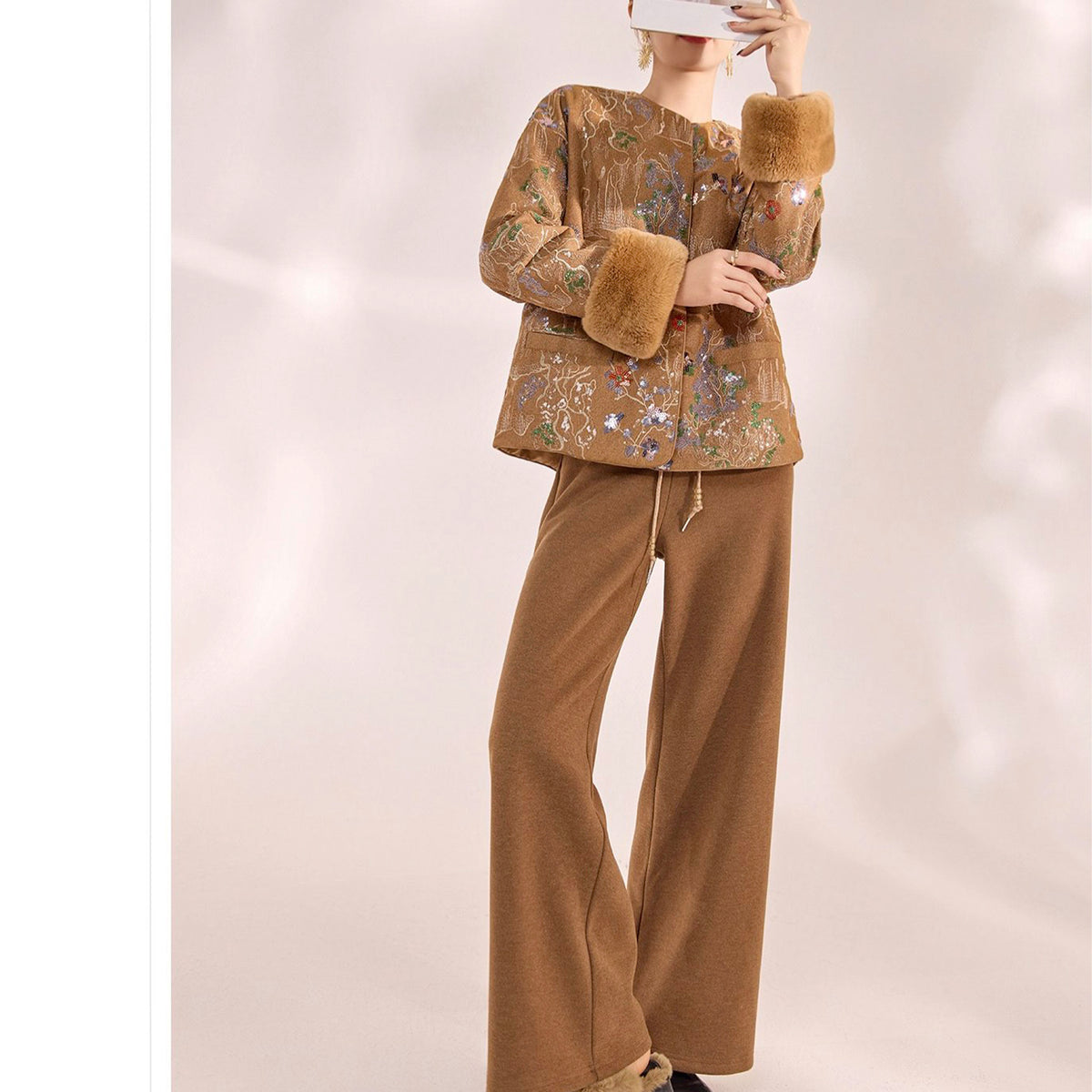 Brown outfit with fur details on a white background