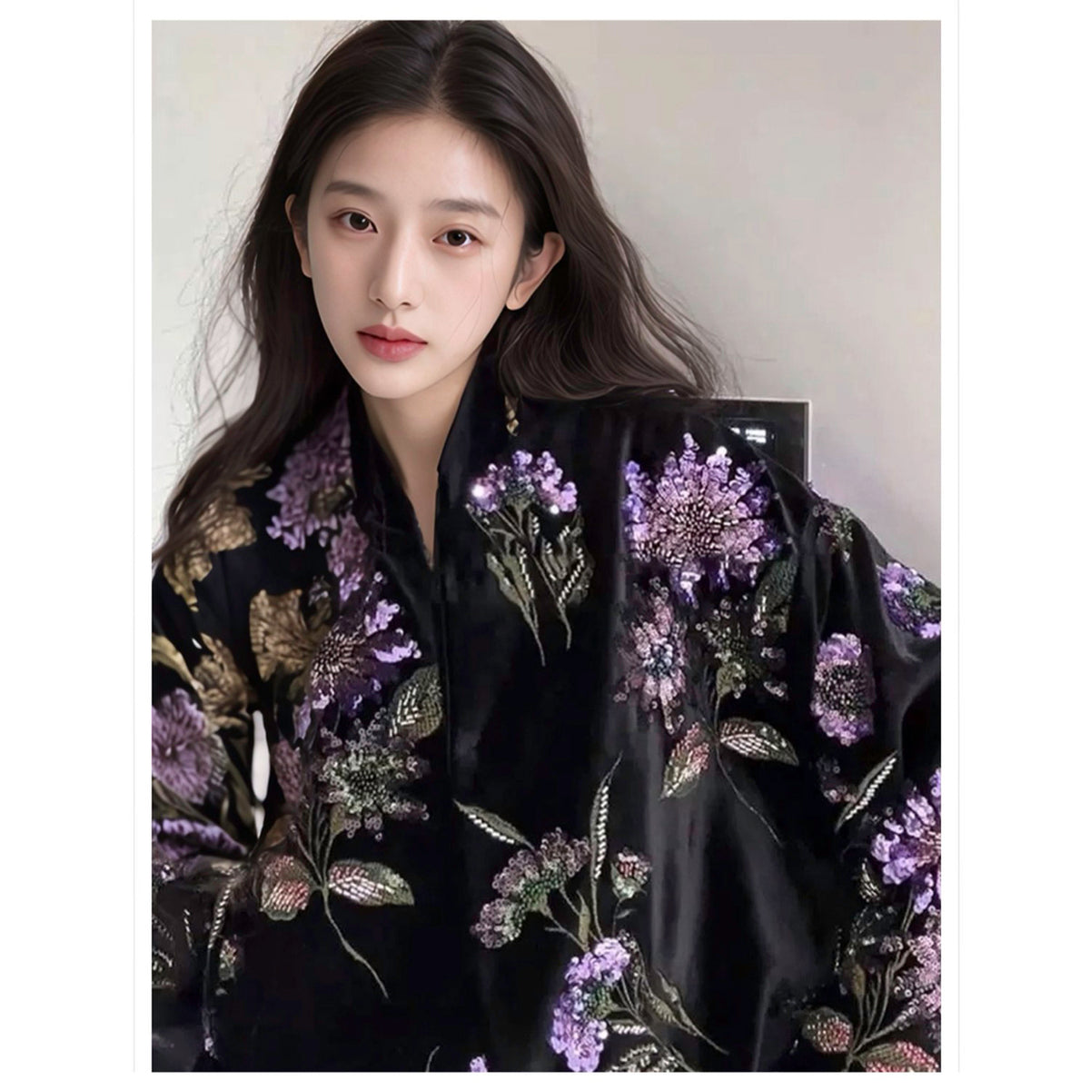 Woman wearing a black embroidered garment with floral patterns