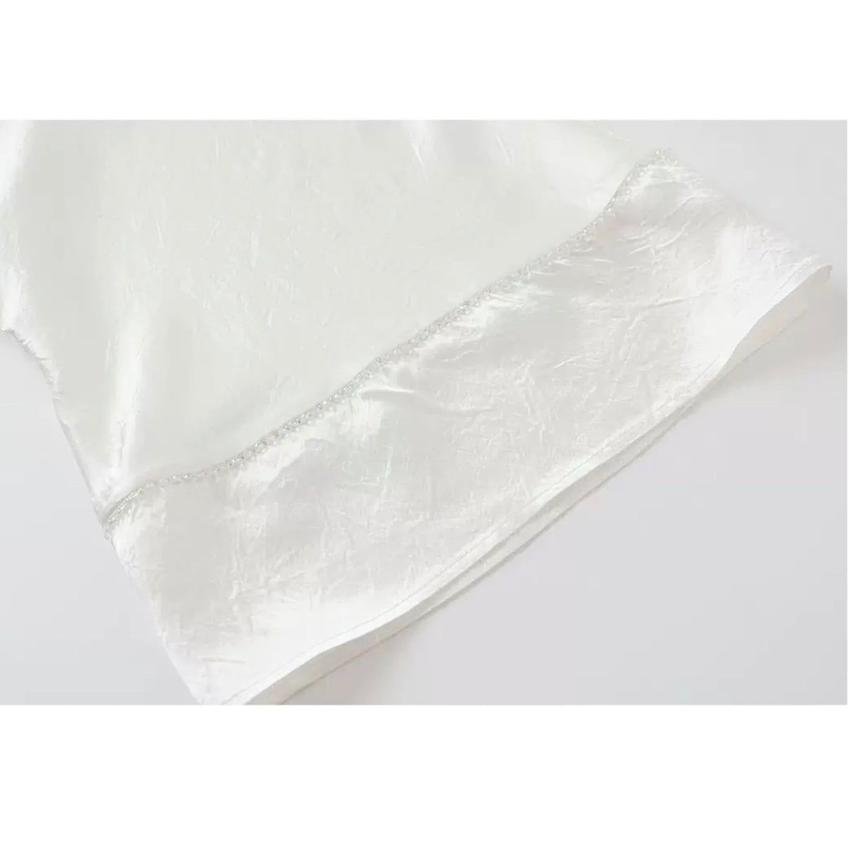White satin pillowcase on a white background