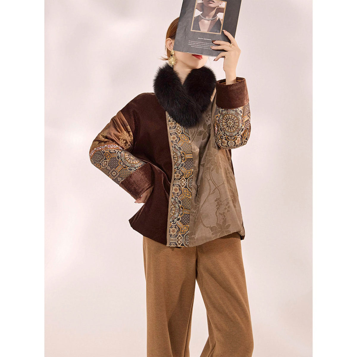 Mannequin wearing a patterned outfit with a fur collar against a plain background