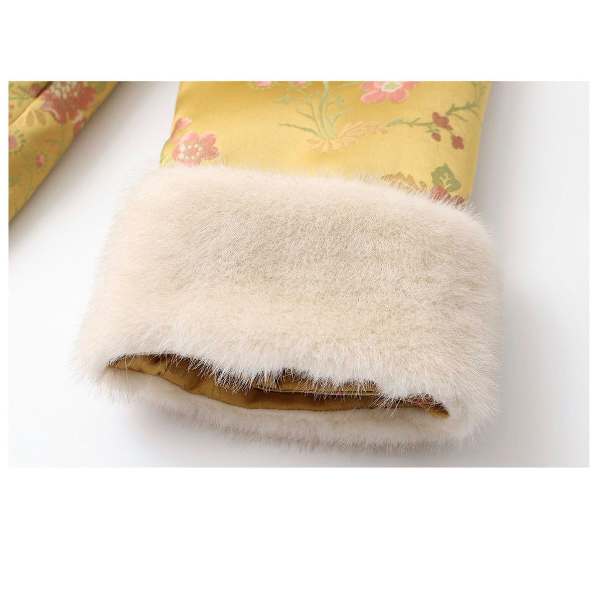 Floral-patterned fabric with a fluffy white trim on a white background