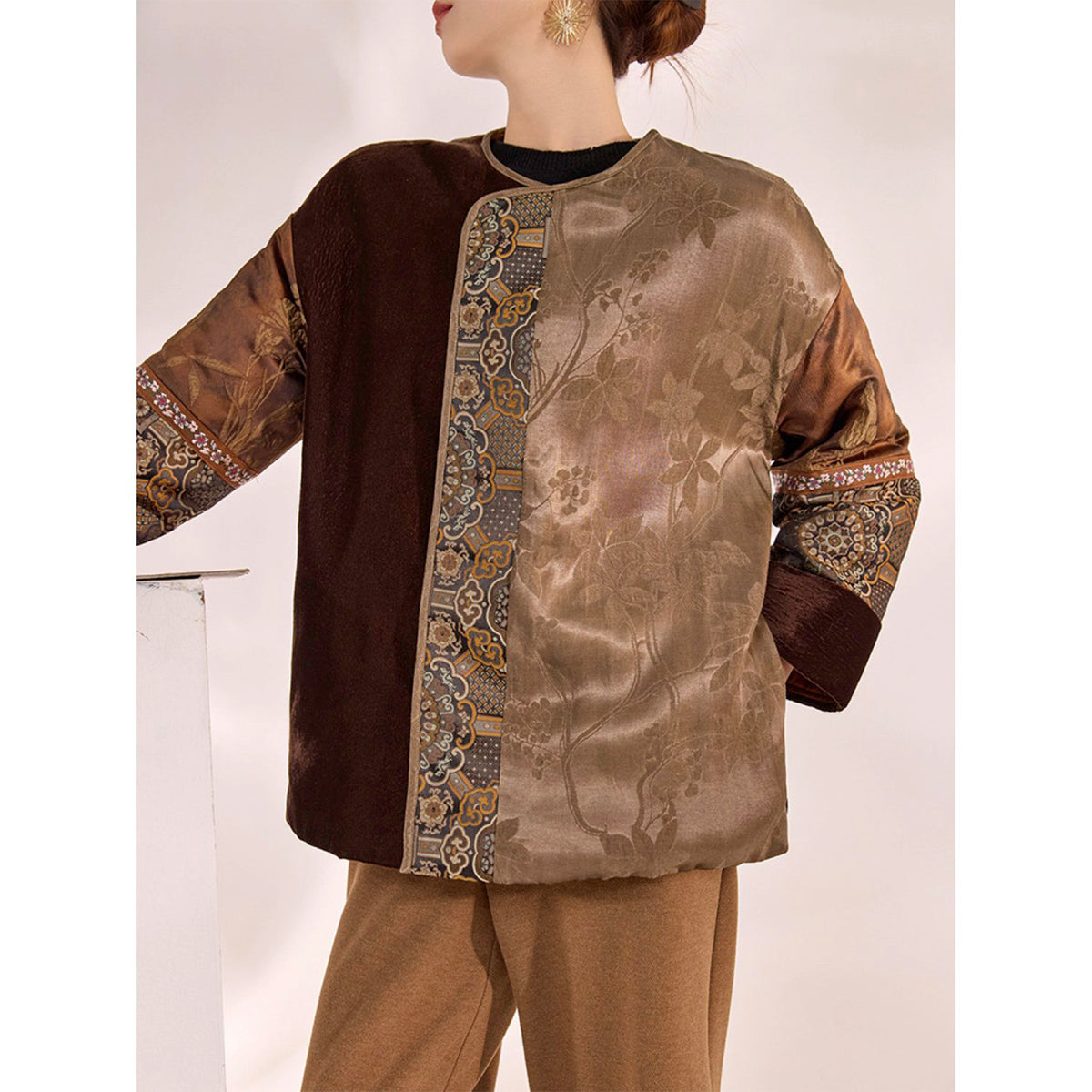 Traditional outfit with a brown and black embroidered top on a white background