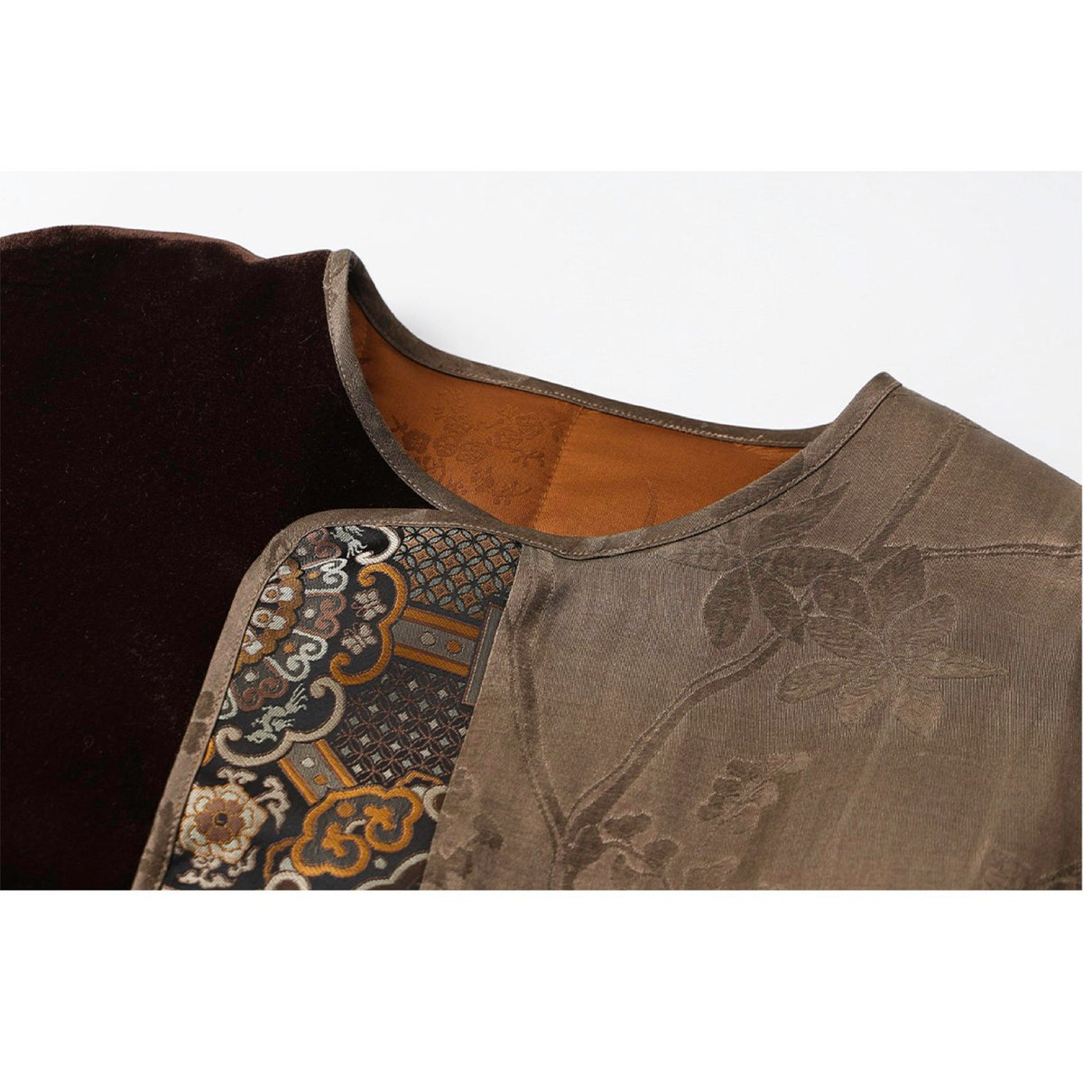 Close-up of a garment with intricate patterns on a white background